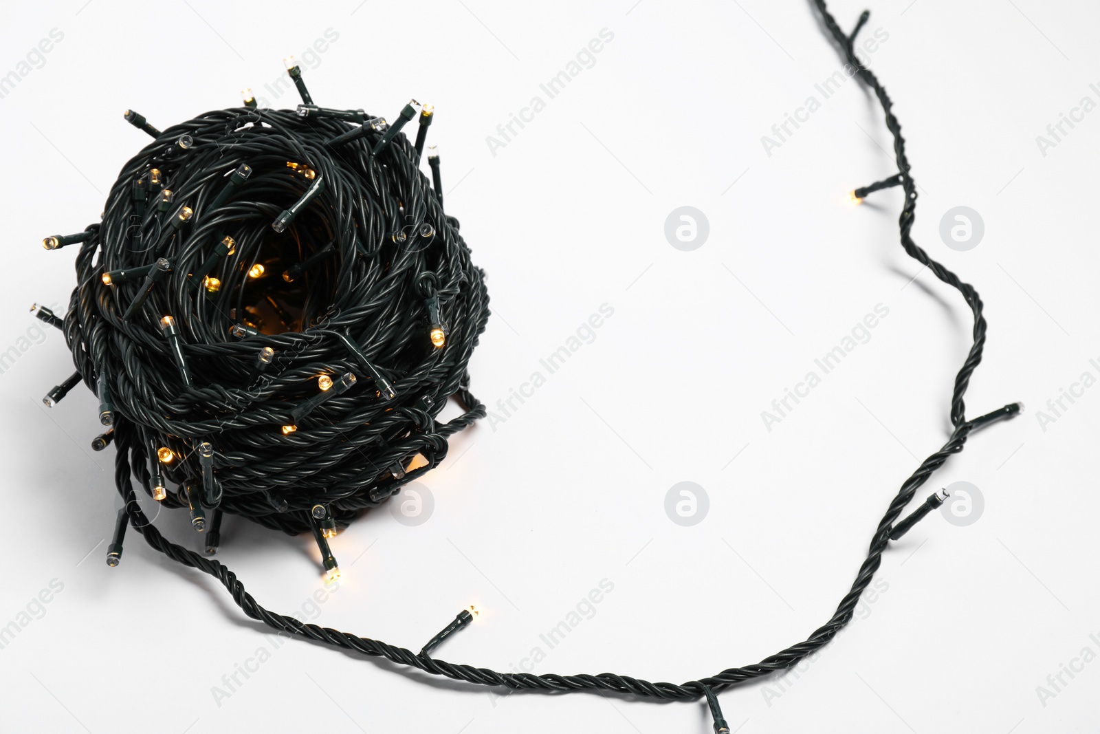 Photo of Bundle of beautiful Christmas lights on white background