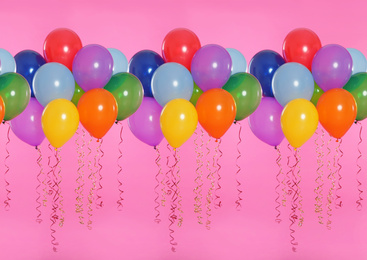 Image of Many color balloons on pink background. Festive decor