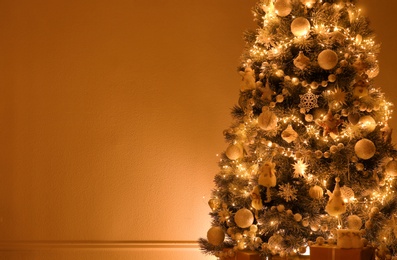 Photo of Beautiful decorated Christmas tree indoors. Space for text
