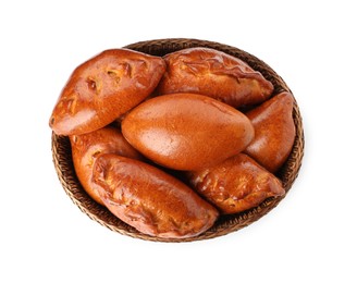 Wicker basket with delicious baked patties on white background, top view