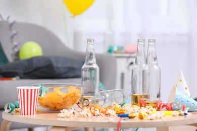 Photo of Wooden table with mess after party indoors