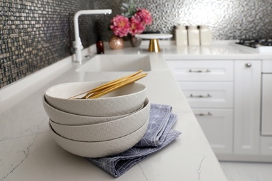 Beautiful ceramic dishware on countertop in modern kitchen