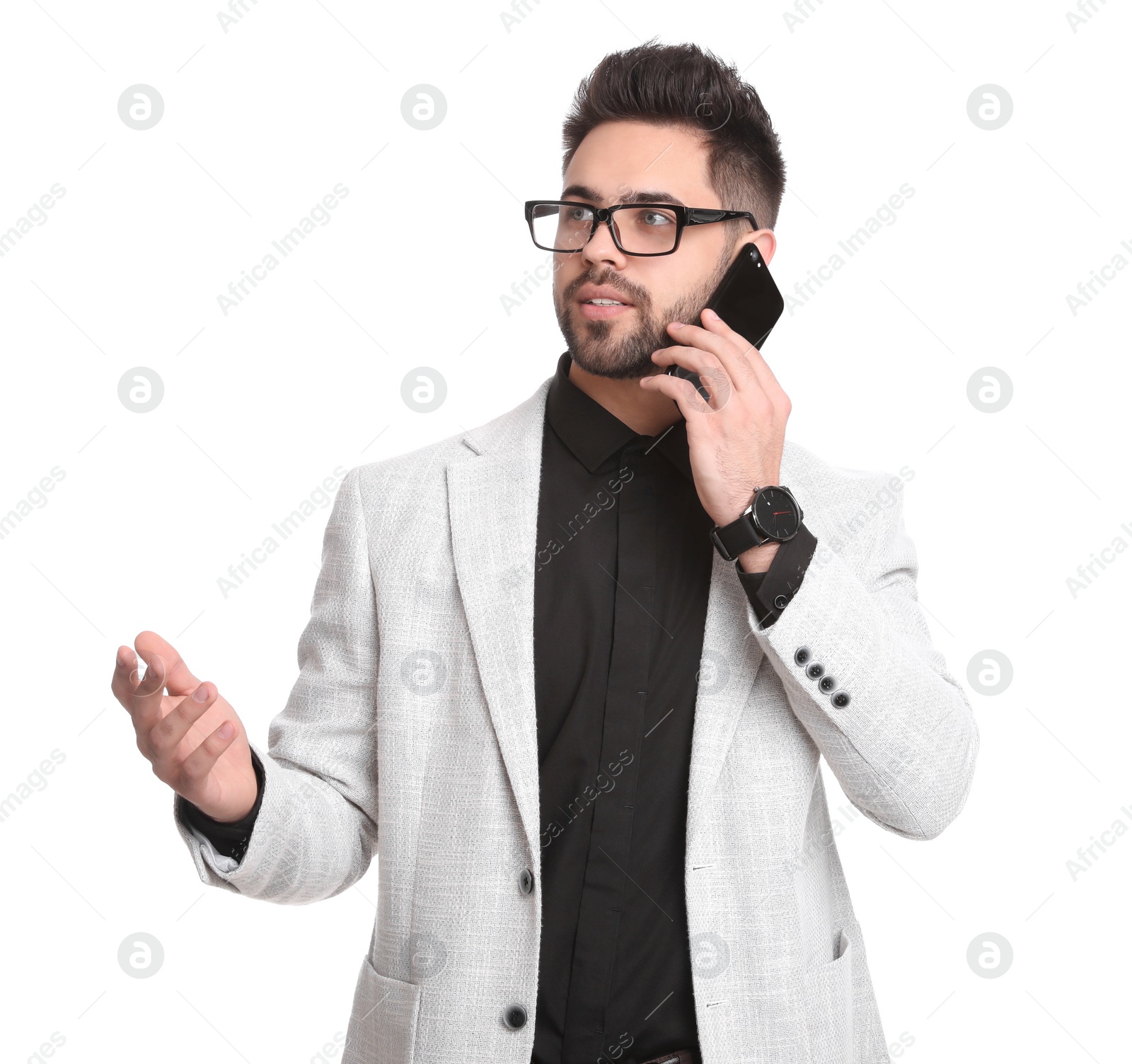 Photo of Young businessman talking on smartphone against white background