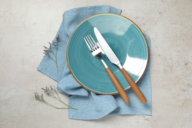 Photo of Setting with beautiful cutlery on textured table, top view