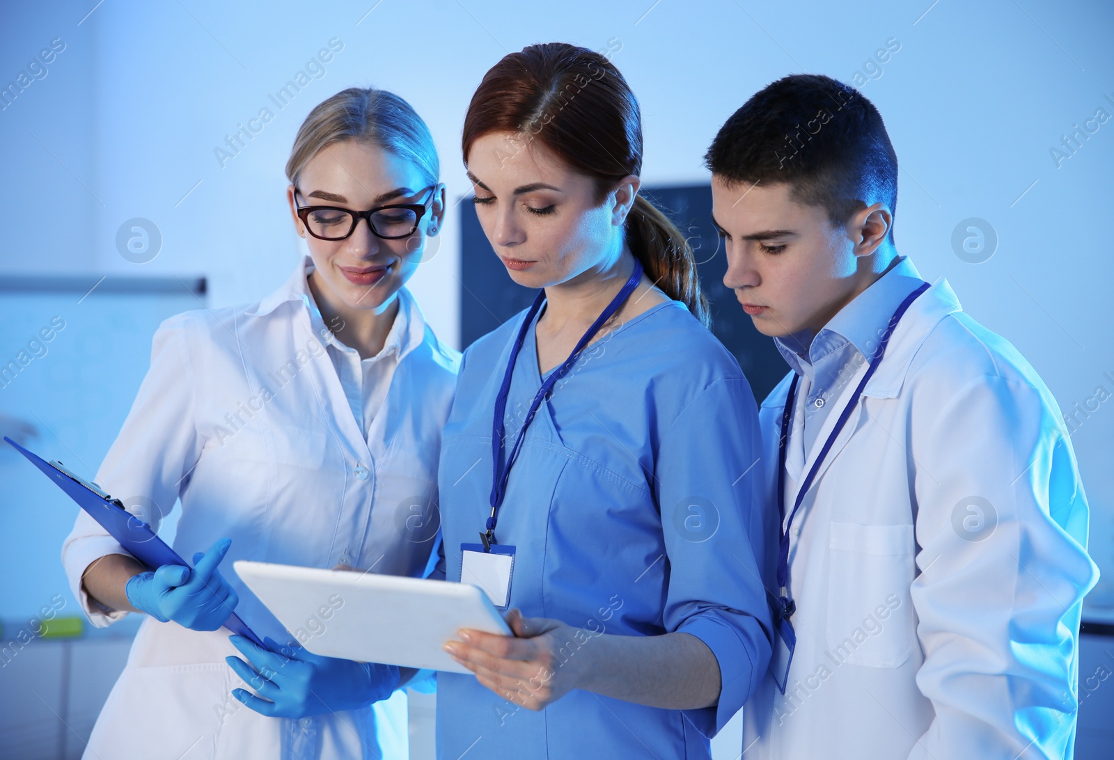 Photo of Group of scientists working in modern chemistry laboratory