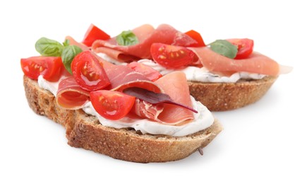 Tasty bruschettas with prosciutto, tomatoes and cheese on white background