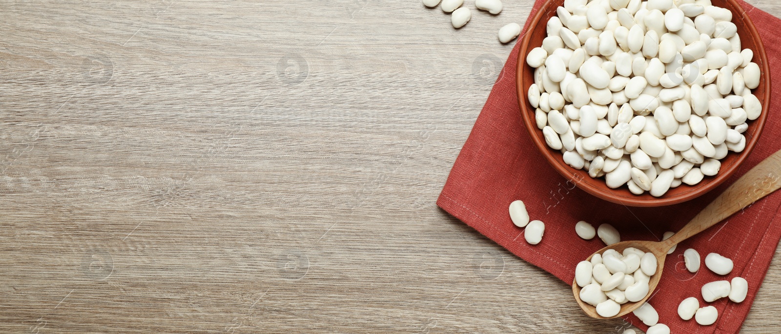 Image of White beans and space for text on wooden table, flat lay. Banner design