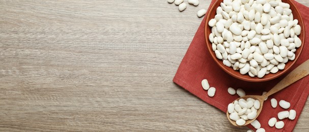 White beans and space for text on wooden table, flat lay. Banner design