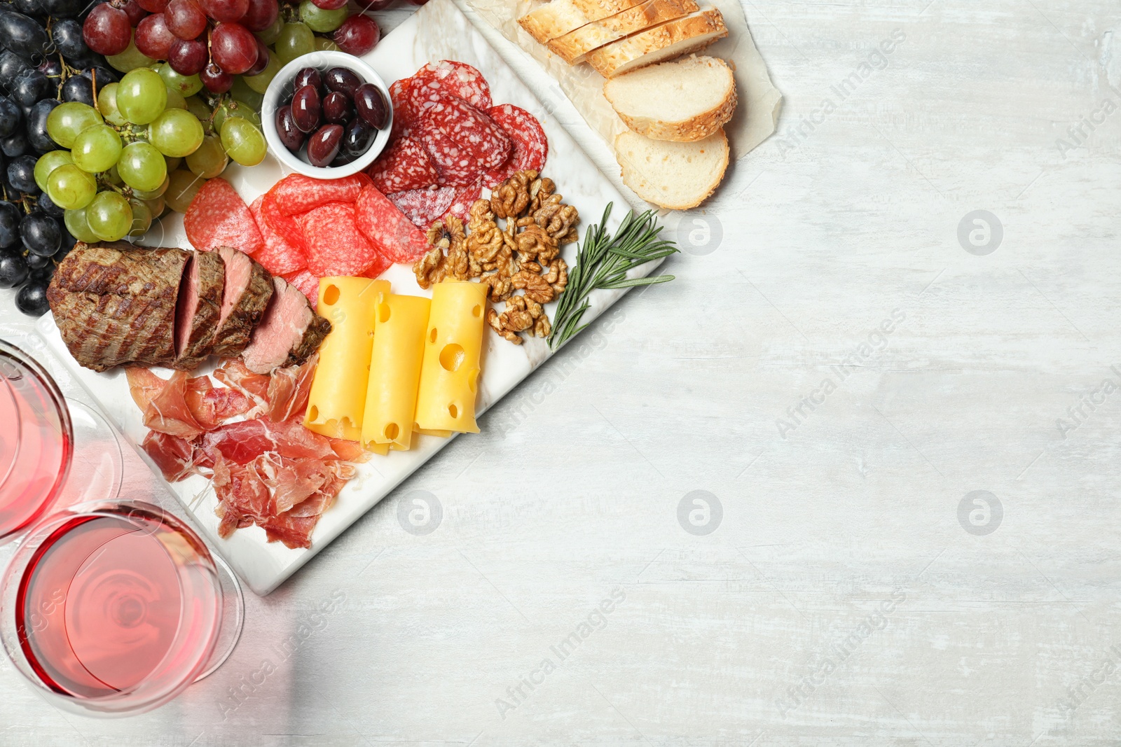 Photo of Flat lay composition with wine, snacks and space for text on white background