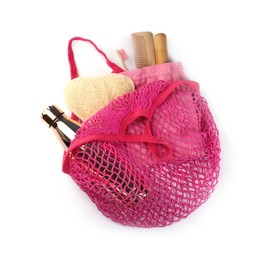 Mesh bag with different items isolated on white, top view. Conscious consumption