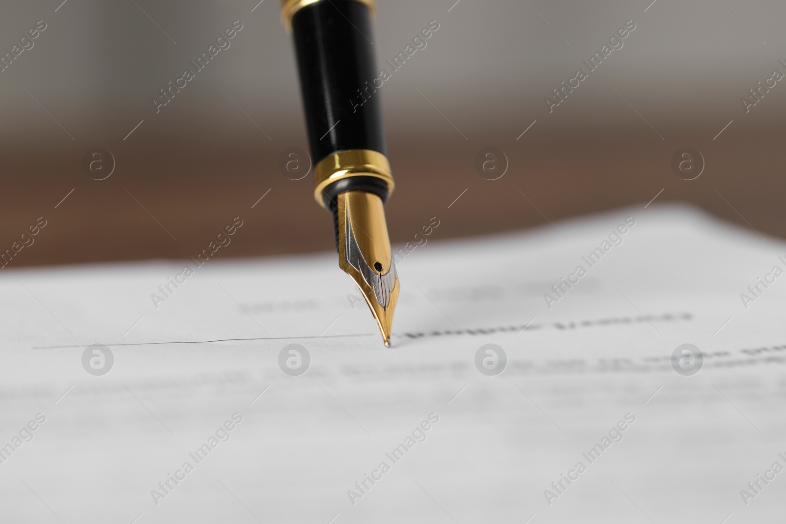 Photo of Writing on document with fountain pen, closeup. Notary contract