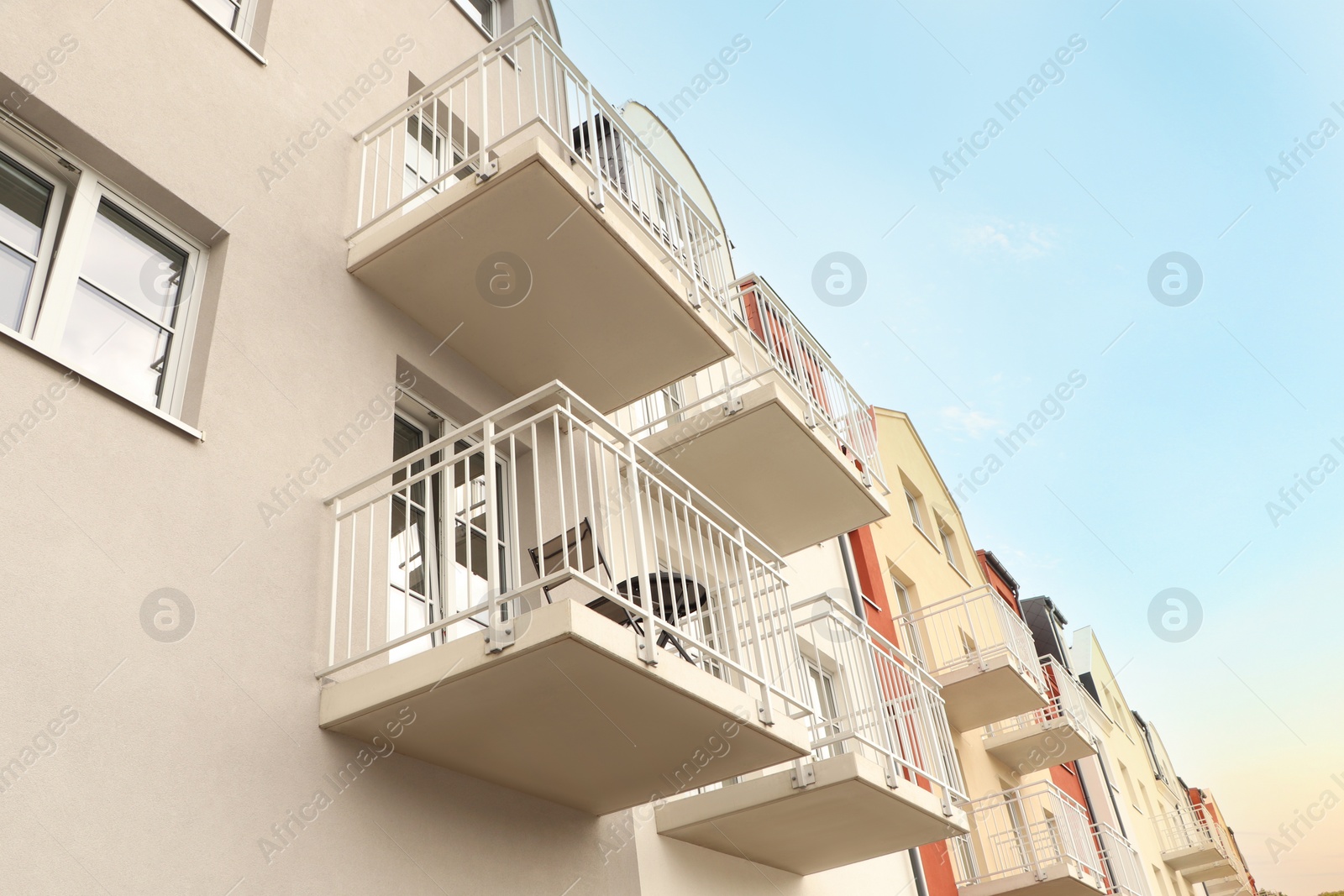 Photo of Exterior of beautiful building with balconies, low angle view