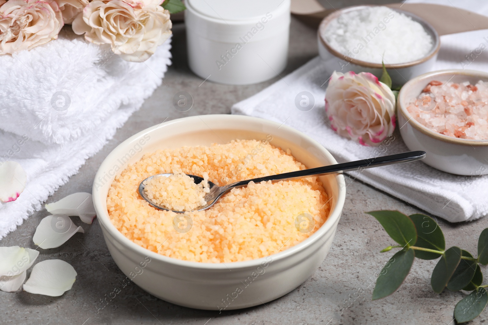 Photo of Beautiful spa composition with sea salt and flowers on grey table