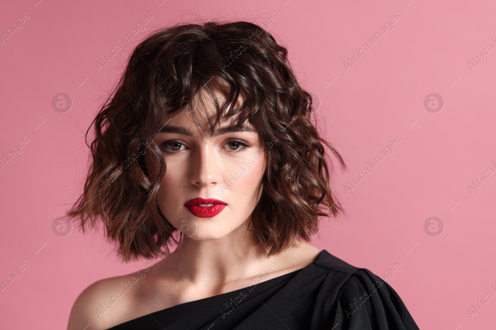 Photo of Portrait of beautiful young woman with wavy hairstyle on pink background. Space for text