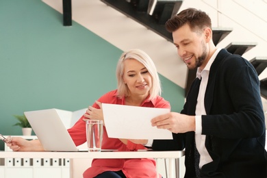 Photo of Mature woman consulting with man in office