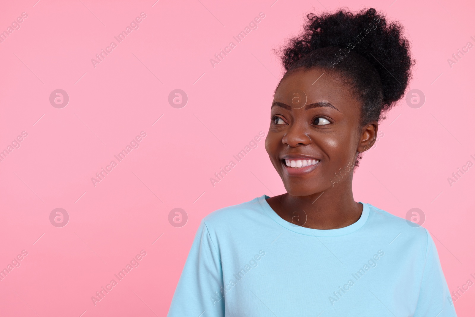 Photo of Portrait of happy young woman on pink background. Space for text