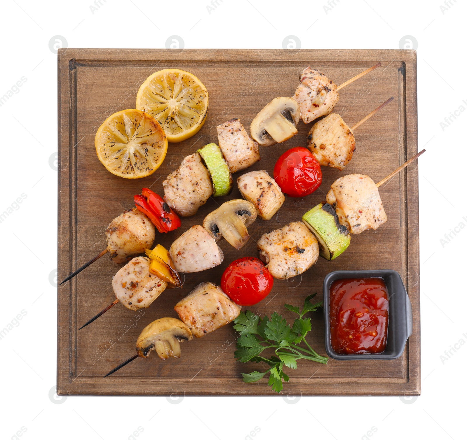 Photo of Wooden board with delicious shish kebabs, tomato sauce and grilled vegetables isolated on white, top view