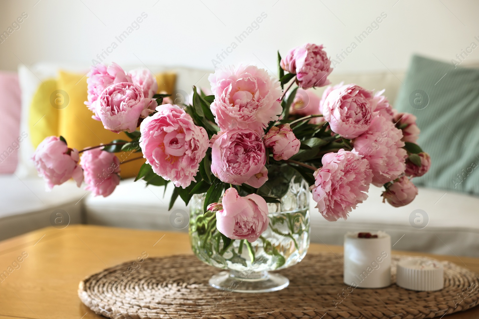 Photo of Beautiful pink peonies in vase on table at home. Interior design