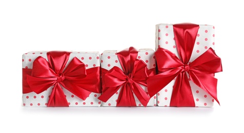 Photo of Beautifully wrapped gift boxes on white background