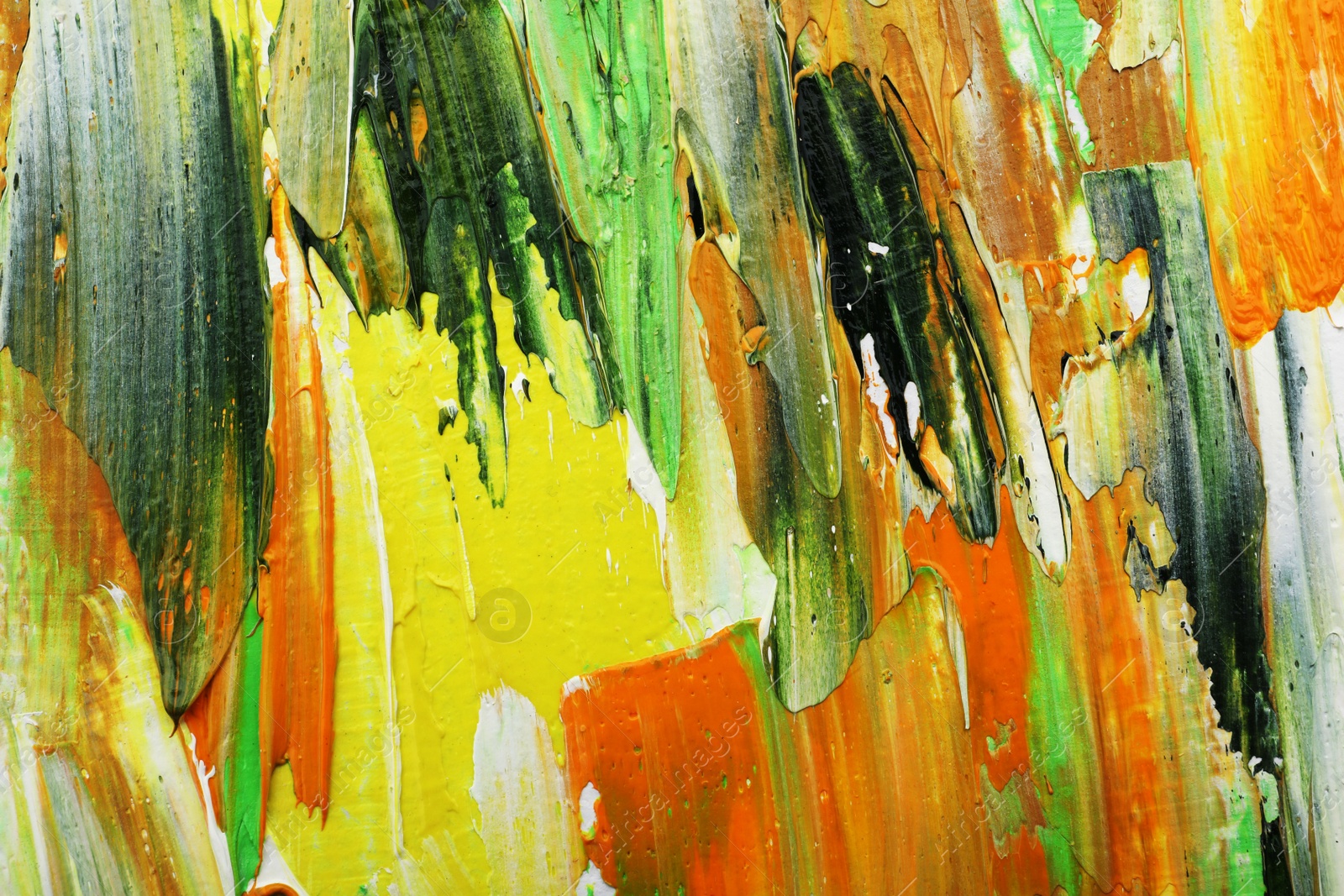 Photo of Beautiful strokes of colorful oil paints as background, closeup