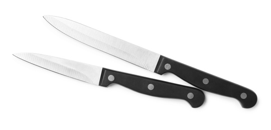 Photo of Stainless steel knives on white background, top view