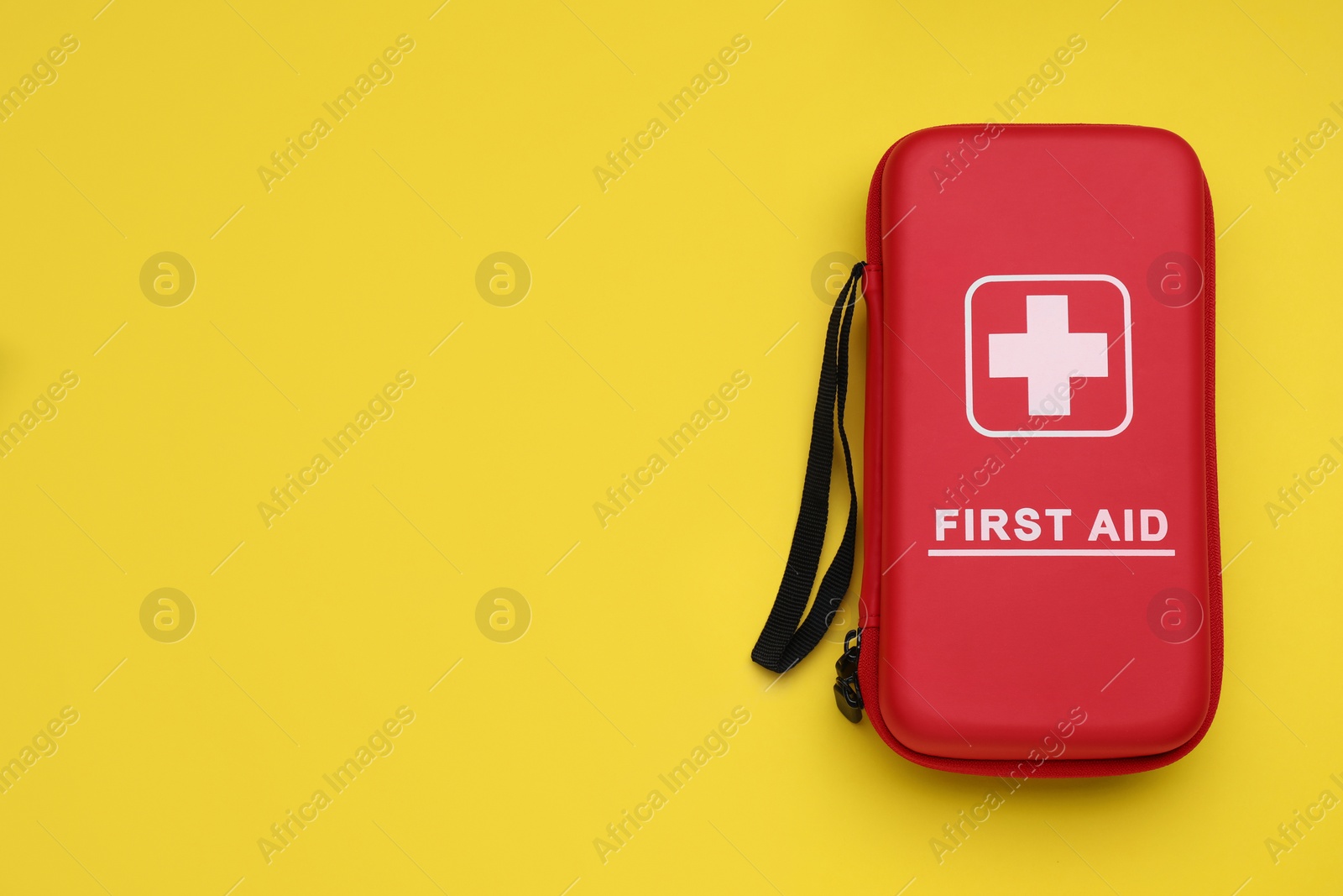 Photo of First aid kit on yellow background, top view and space for text