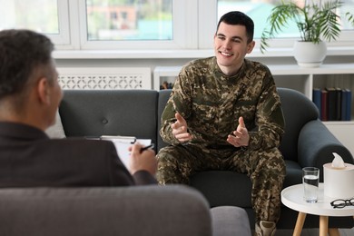 Photo of Professional psychotherapist working with military man in office