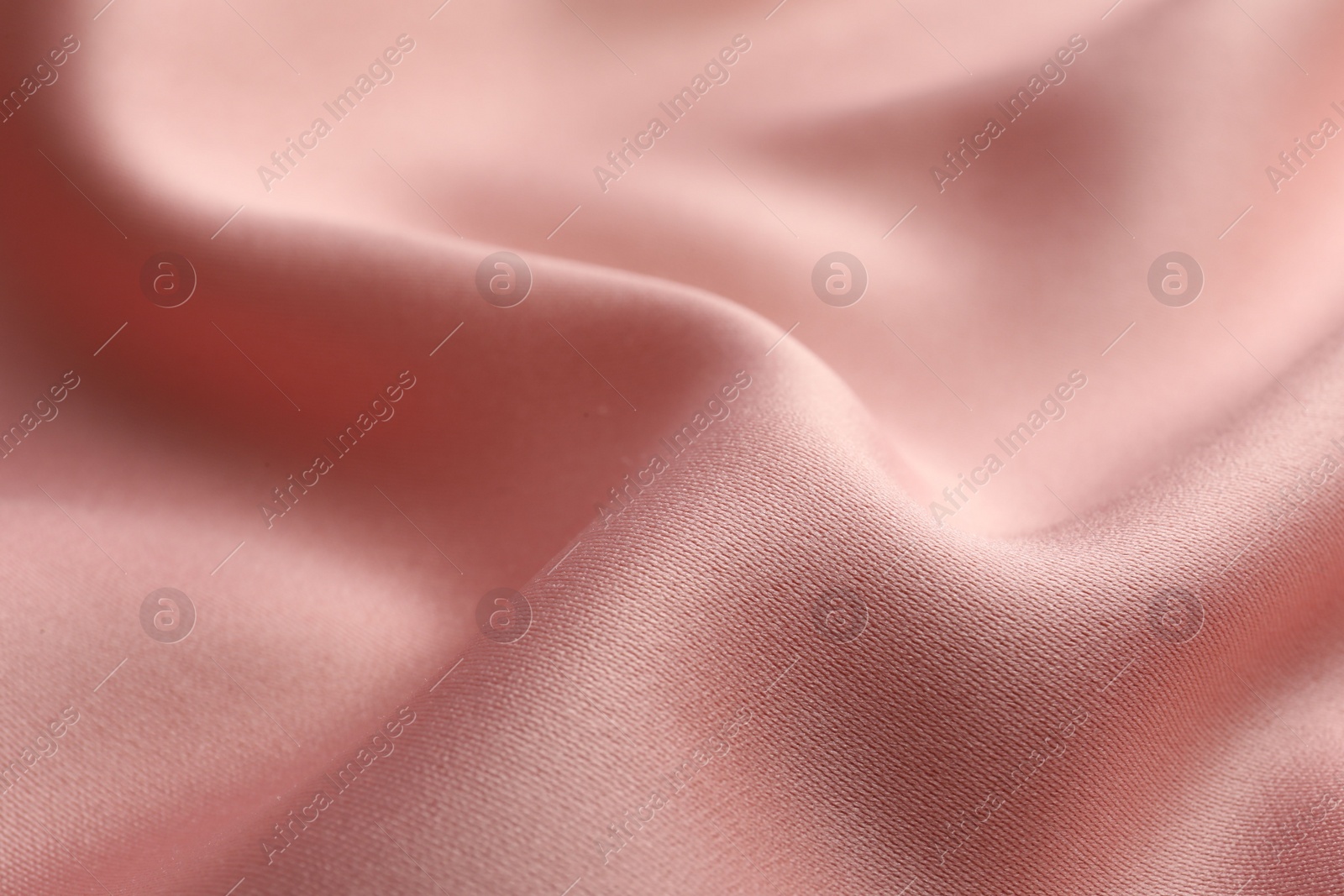 Photo of Texture of pink silk fabric as background, closeup