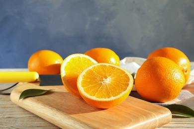 Fresh juicy oranges on wooden cutting board