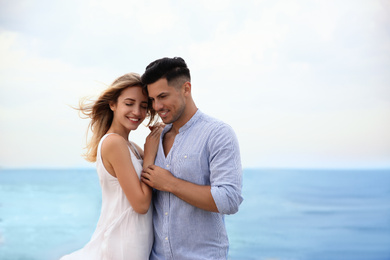 Happy couple on beach, space for text. Romantic walk