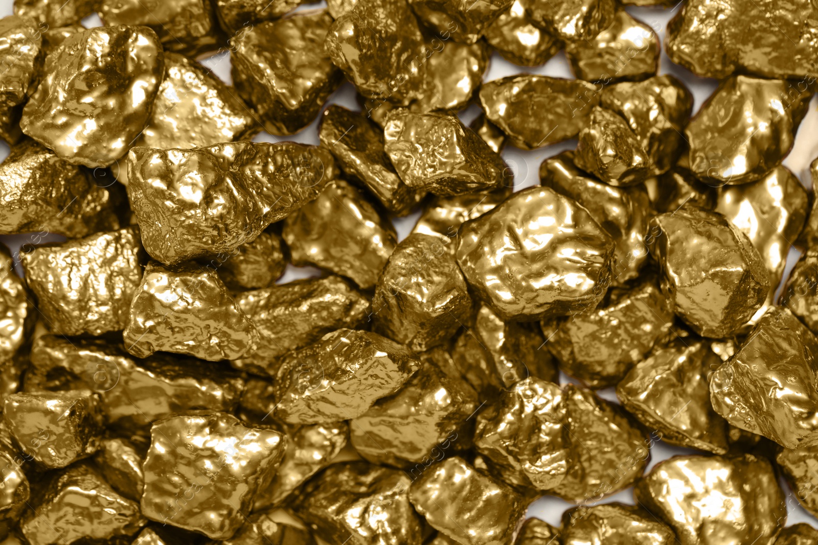 Photo of Pile of gold nuggets as background, top view