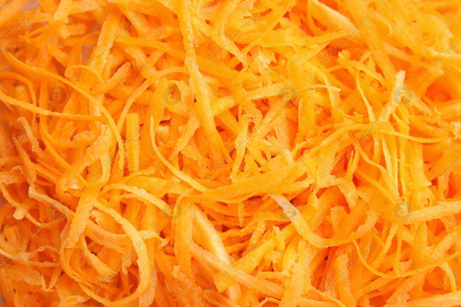 Photo of Grated ripe carrot as background