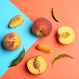 Photo of Flat lay composition with fresh peaches on color background