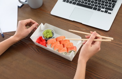 Photo of Office employee having lunch at workplace, closeup. Food delivery