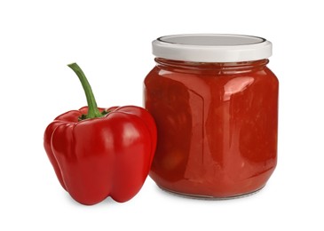 Glass jar of delicious canned lecho and fresh bell pepper on white background