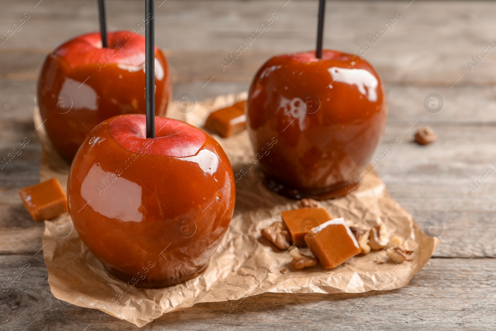 Photo of Delicious red caramel apples on table