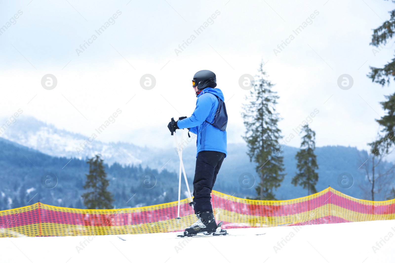 Photo of Skier on slope at resort. Winter vacation