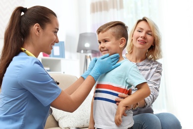 Children's doctor visiting little boy at home