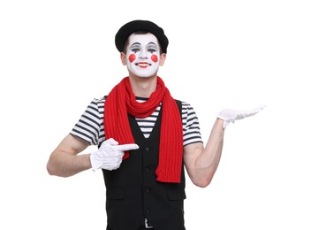 Photo of Funny mime artist pointing at something on white background