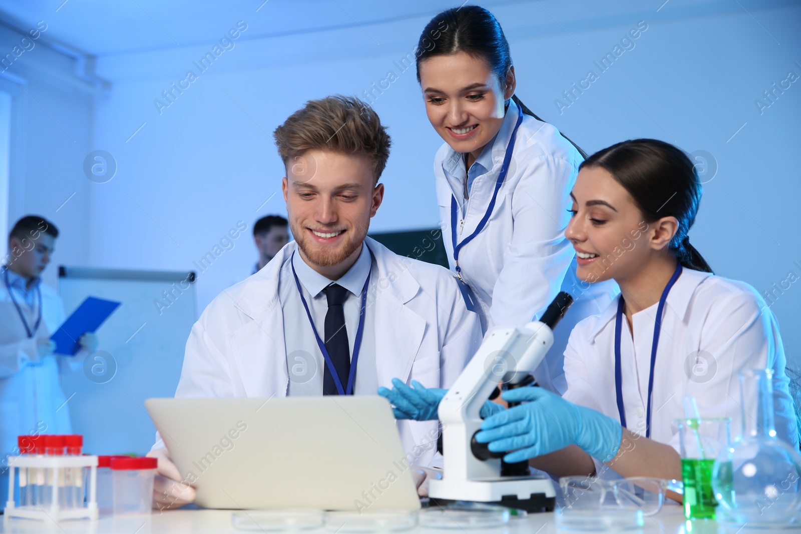 Photo of Group of scientists working in modern chemistry laboratory