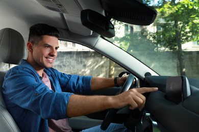 Photo of Man using navigation system while driving car