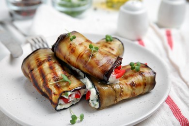 Photo of Delicious baked eggplant rolls served on table, closeup