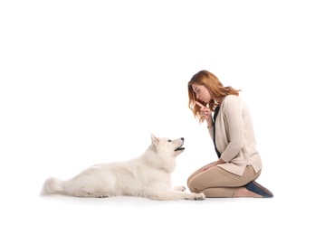 Beautiful woman with her cute dog on white background