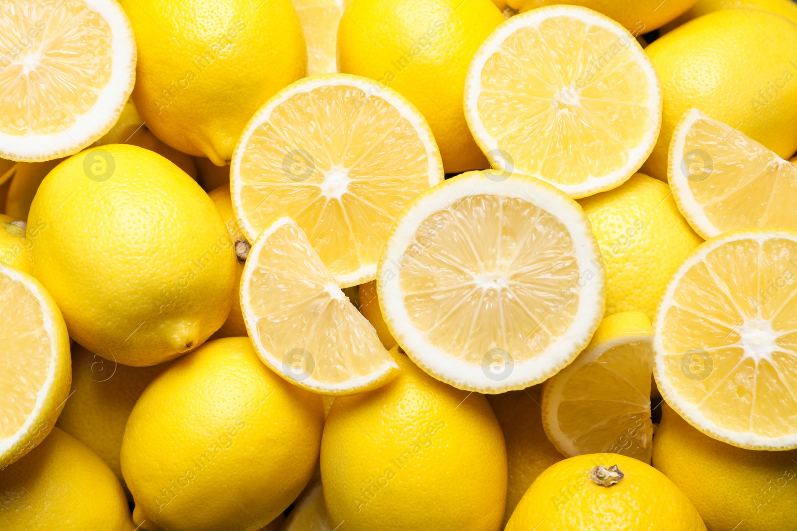 Photo of Many fresh ripe lemons as background, closeup