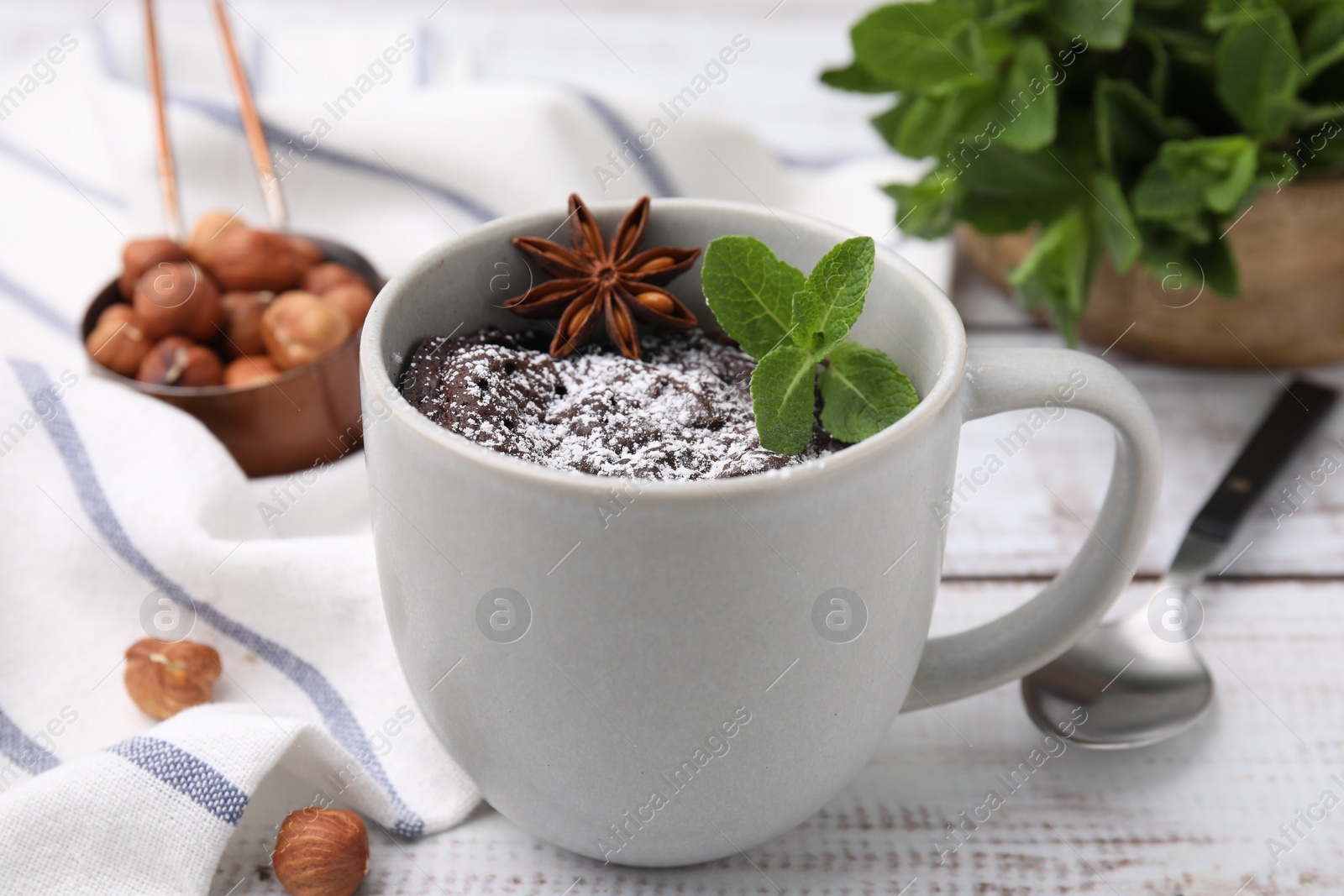 Photo of Tasty chocolate mug pie on white table. Microwave cake recipe