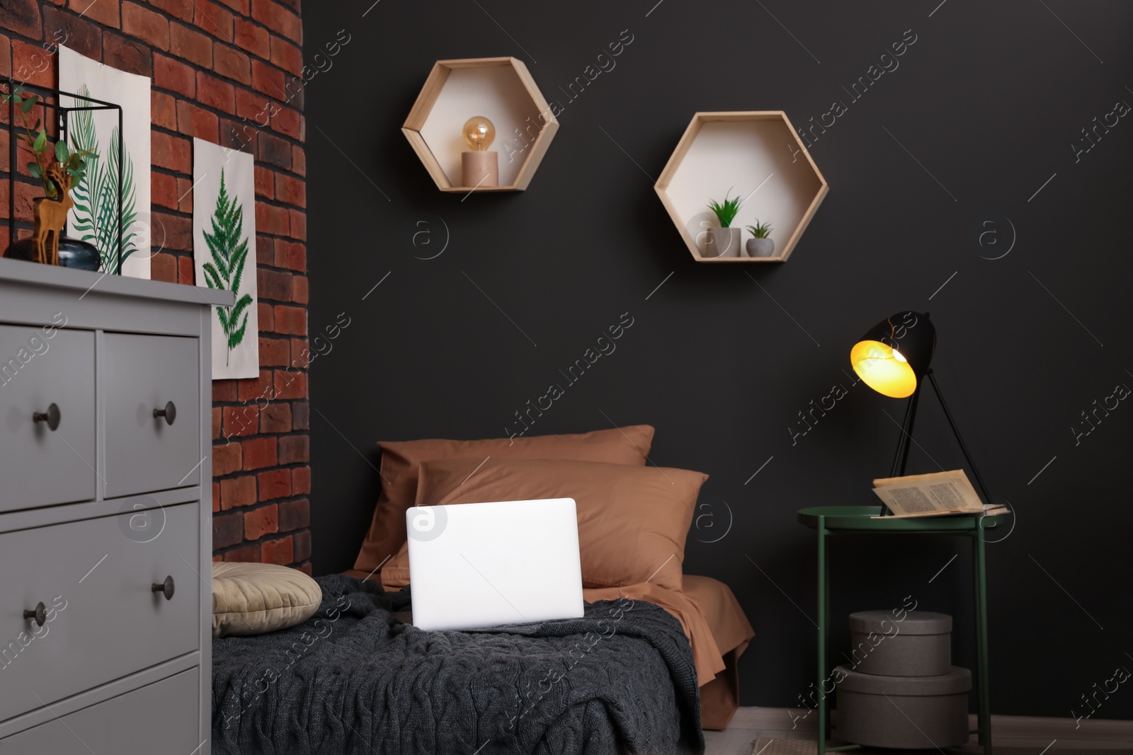 Photo of Stylish teenager's room with laptop, bed and chest of drawers