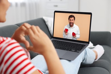 Image of Long distance love. Woman having video chat with her boyfriend via laptop at home, closeup