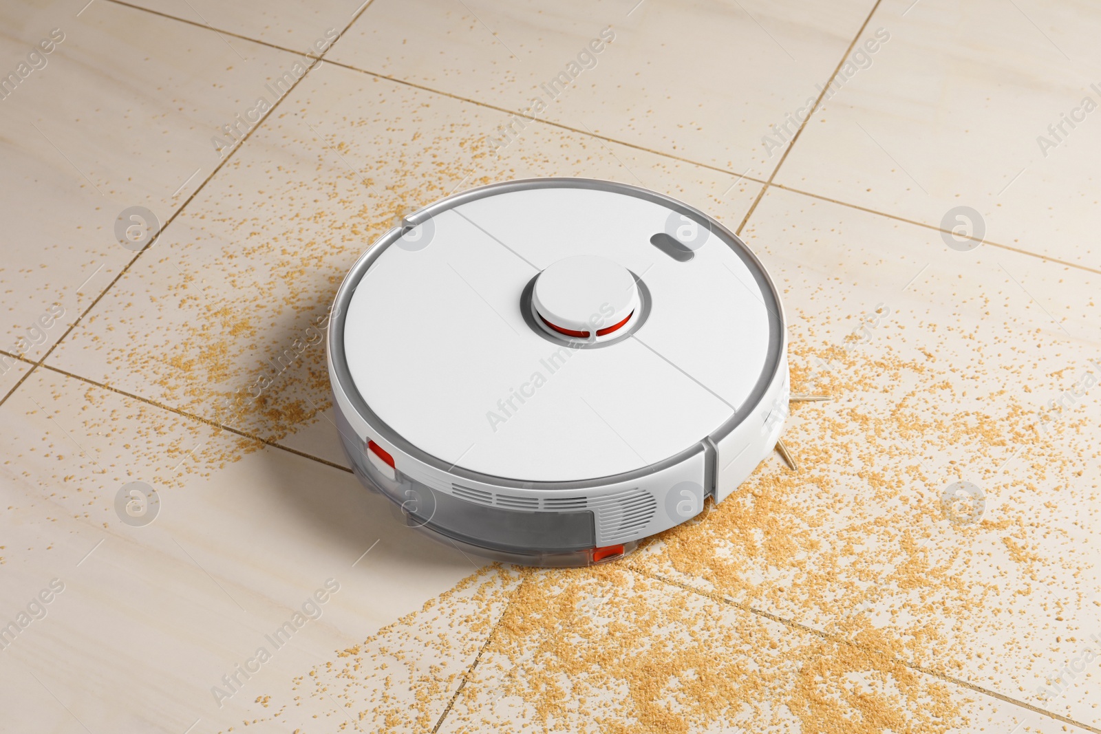 Photo of Robot vacuum cleaner removing dirt from floor in room