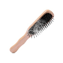 Photo of Wooden brush with lost hair in air on white background