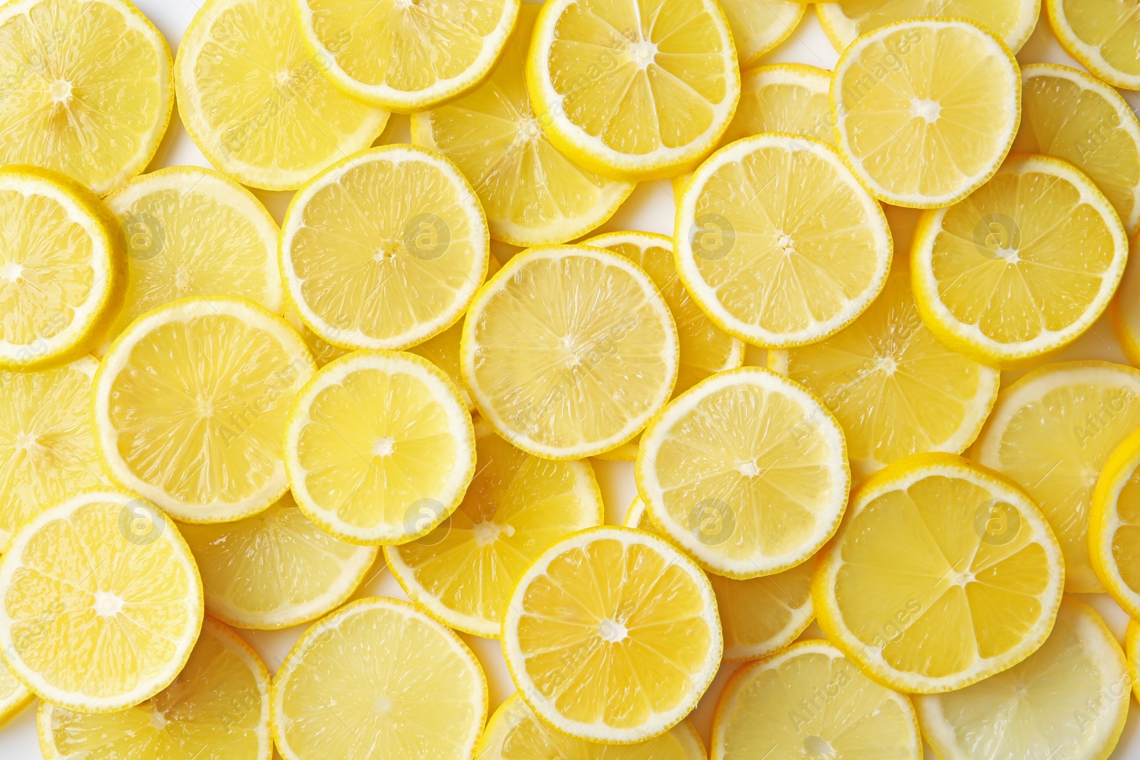 Photo of Many slices of fresh ripe lemons as background